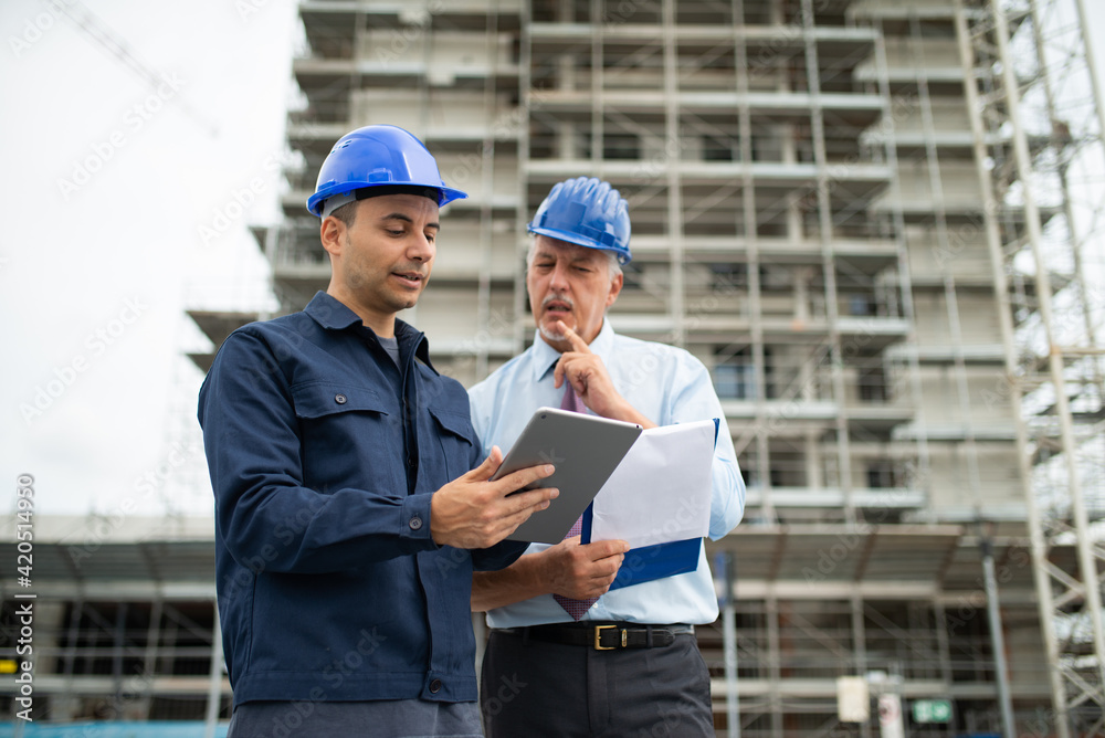 Architect and site manager using a tablet Architect and site manager using a tablet