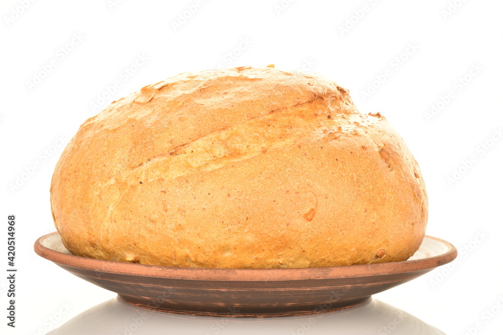 One loaf of delicious white bread on a clay plate, close-up, isolated on white. One loaf of delicious white bread on a clay plate, close-up, isolated on white.