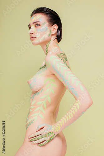 Side view naked woman with floral body art