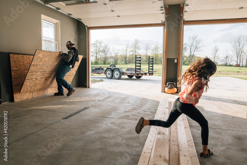Man working in garage with girl. photo