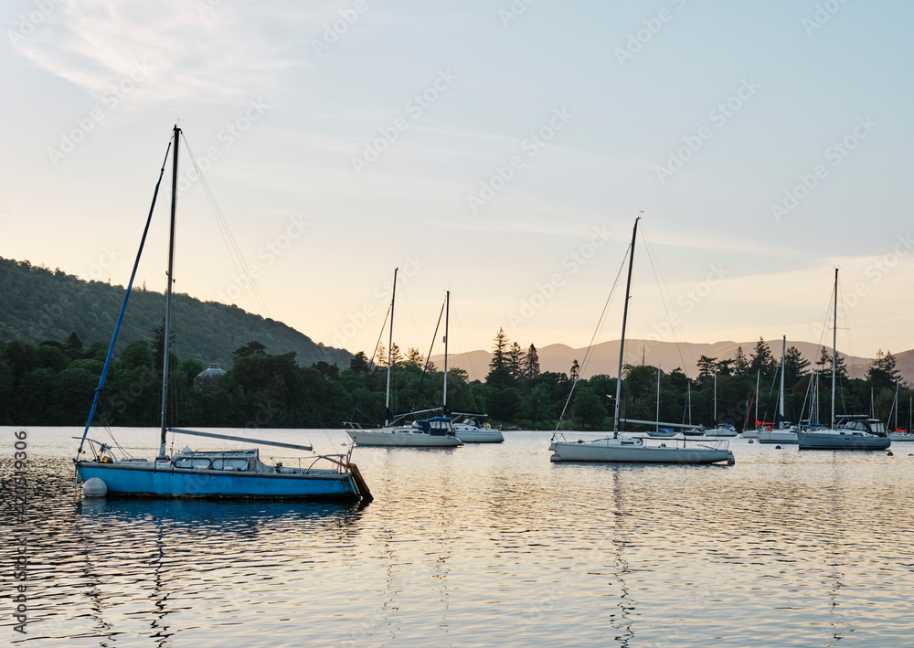 Sailing boats on Lake Windermere at sunset. Ferry Nab, Lake District, Cumbria, UK. Sailing boats on Lake Windermere at sunset. Ferry Nab, Lake District, Cumbria, UK.