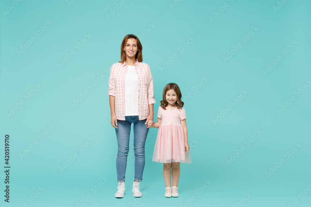 Full length happy woman in pink clothes have fun with cute child baby girl 5-6 years old. Mommy little kid daughter isolated on pastel blue azure background studio. Mother's Day love family concept. Full length happy woman in pink clothes have fun with cute child baby girl 5-6 years old. Mommy little kid daughter isolated on pastel blue azure background studio. Mother's Day love family concept.