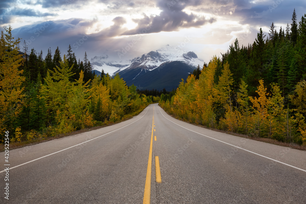 Scenic road in the Canadian Rockies during a vibrant sunny and cloudy summer morning. Dramatic Sky Artistic Render. Taken in Icefields Parkway, Banff National Park, Alberta, Canada. Scenic road in the Canadian Rockies during a vibrant sunny and cloudy summer morning. Dramatic Sky Artistic Render. Taken in Icefields Parkway, Banff National Park, Alberta, Canada.