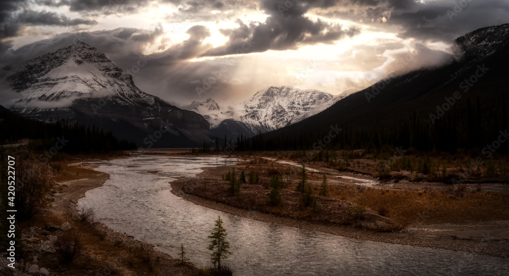 Scenic panoramic view of the Canadian Rocky Mountain Landscape during Fall Season. Dramatic Sunset Sky Art Render. Taken in Icefields Pkwy, Jasper, Alberta, Canada.