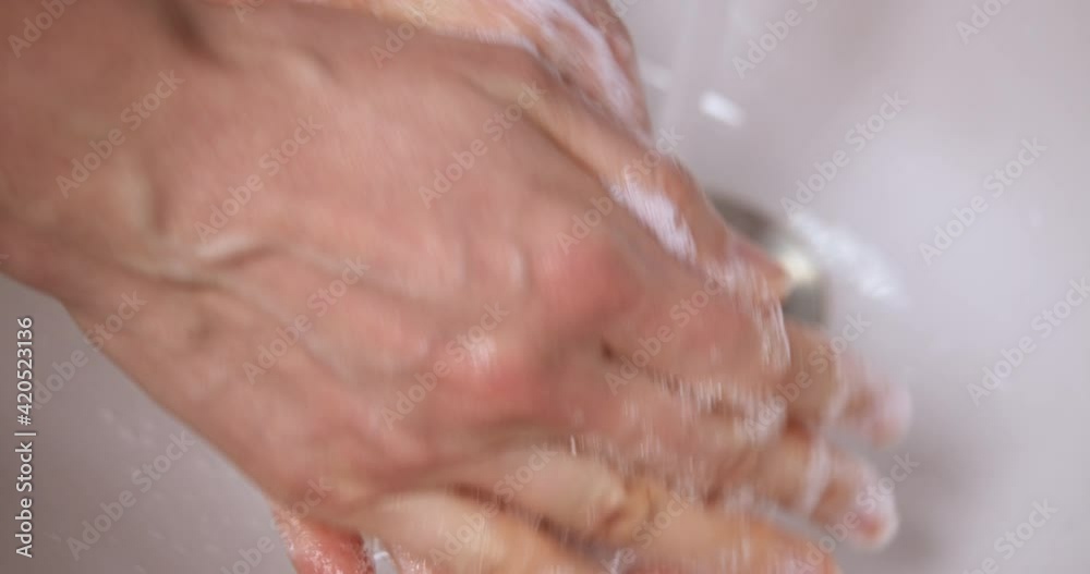 Macro, extreme close up of hands cleaning. A woman washes her hands with soap.