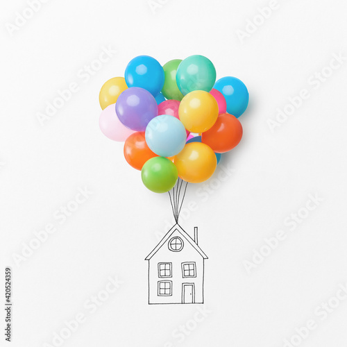 Drawing of a house with colorful air balloons. photo