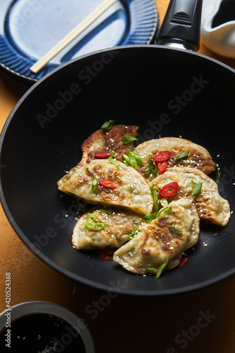 Fried gedza dumplings on wok pan photo