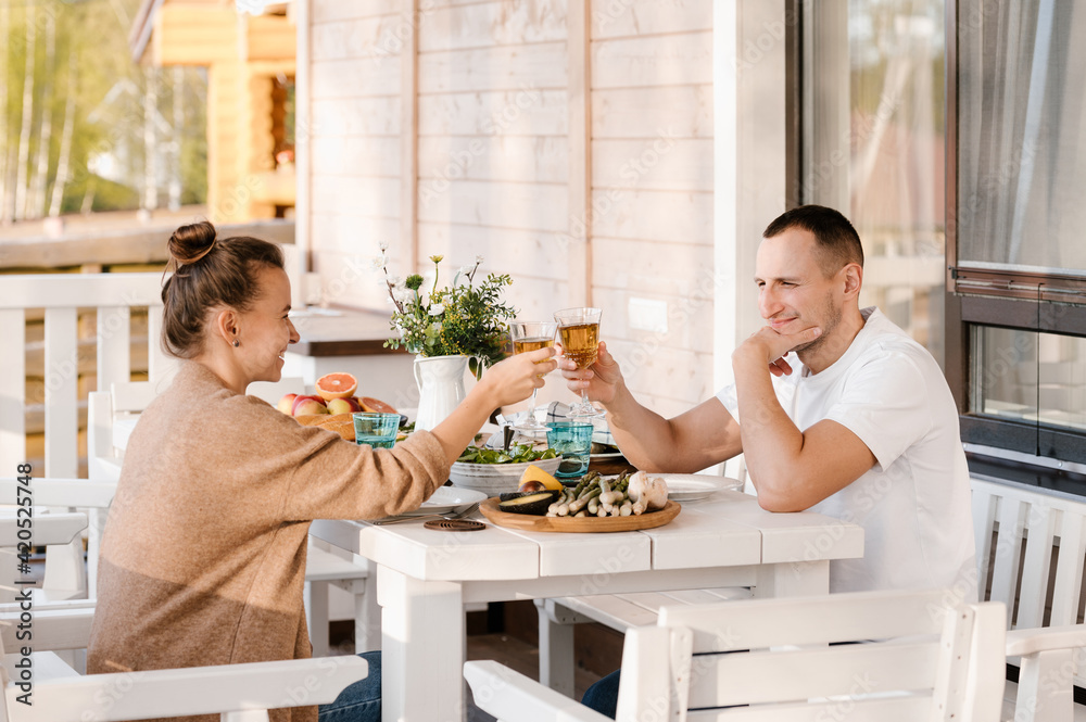 Happy couple clinking glasses on terrace Happy couple clinking glasses on terrace