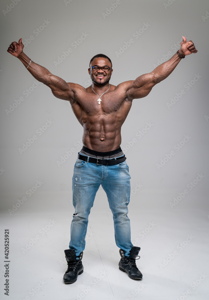 Muscular bodybuilder showing his muscles in studio. Handsome athletic man with naked torso posing for camera. Muscular bodybuilder showing his muscles in studio. Handsome athletic man with naked torso posing for camera.