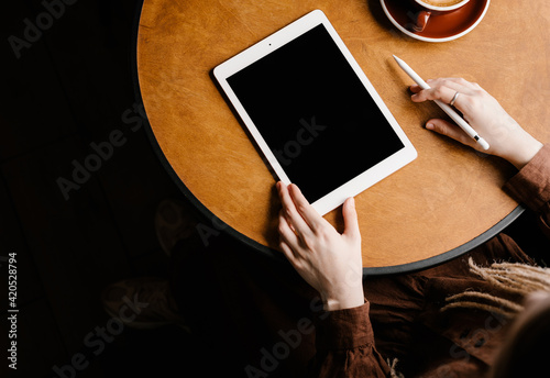Modern woman with tablet working in cafe