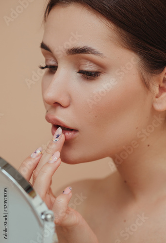 Pretty model apply lip gloss