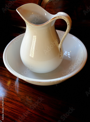 фотографія Old white ceramic hand wash basin and water pitcher