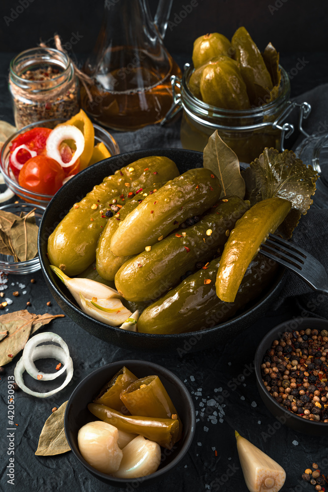 Still life with pickled cucumbers on a black background. Still life with pickled cucumbers on a black background.