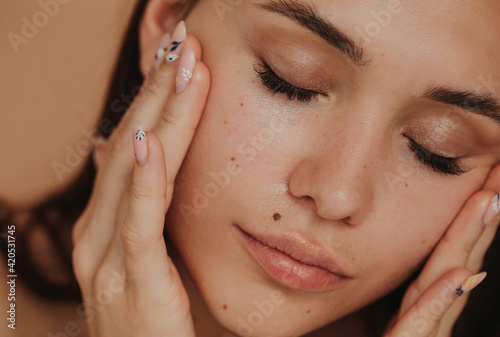Closeup attractive woman massaging her face