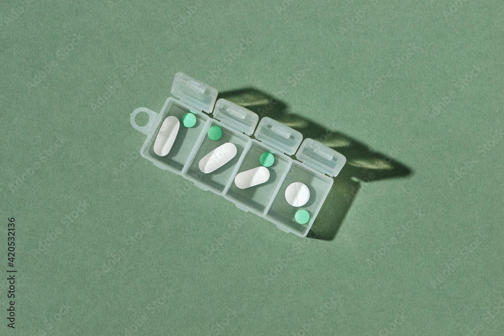© Maki Company Limited/Stocksy - Daily drug dose - pills organized in a pill box