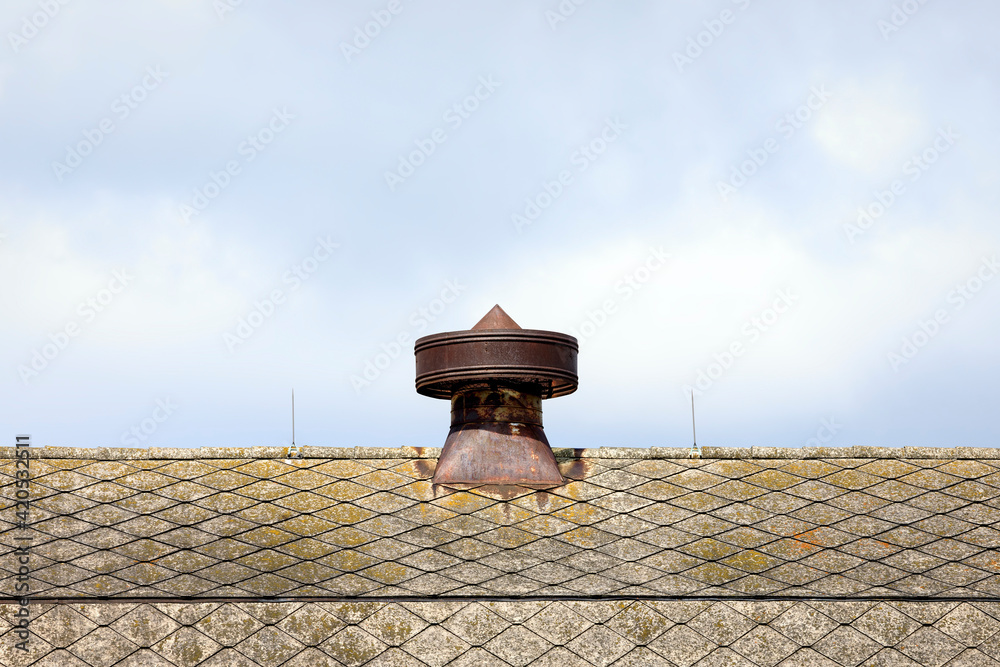 Old and Rusty Metal Barn Cupola atop the Shingled Roof of a Barn with