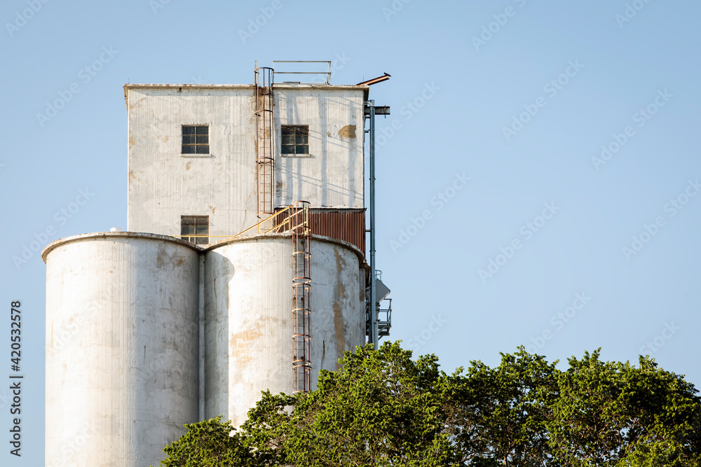 Top of an Old Grain Elevator against a Blue Sky Top of an Old Grain Elevator against a Blue Sky
