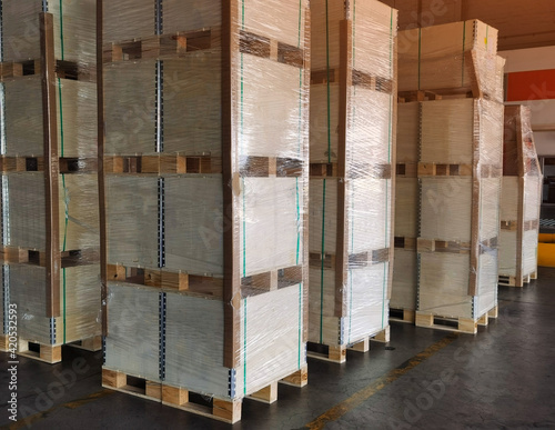 Shipment cartons box on pallets and wooden case on hand lift in interior warehouse cargo for export and sorting goods in freight logistics and transportation industrial, delivery service