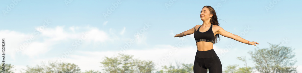 Fototapeta premium Young attractive woman doing exercise working outdoors.