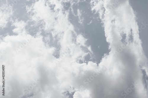 Toned daylight sky with many white clouds in grey colors