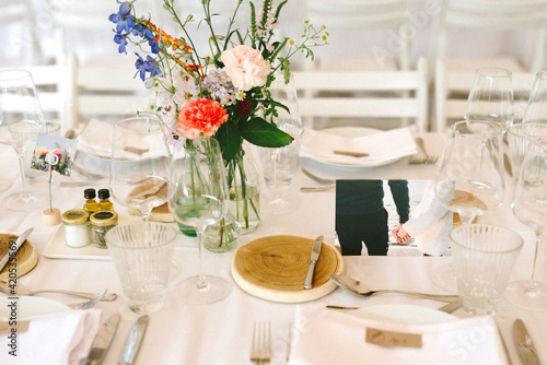 table set up for a wedding with flowers, and cards photo