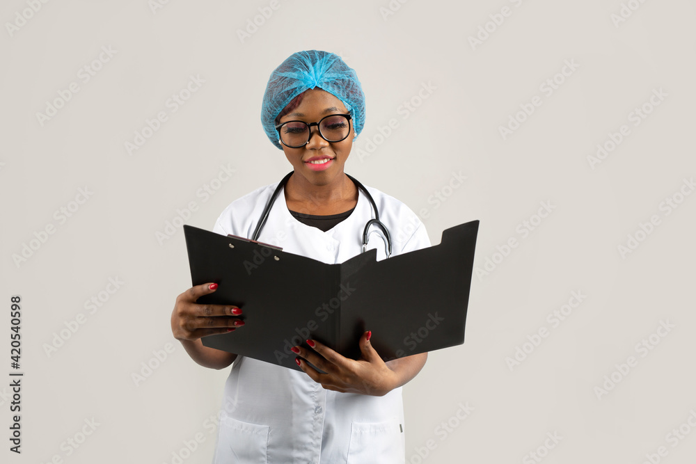 beautiful young african woman in a medical gown on a white background beautiful young african woman in a medical gown on a white background