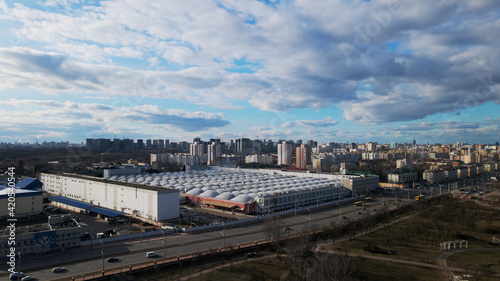 Megapolis in the spring. The factory is visible. Around it are high-rise city houses. © f2014vad