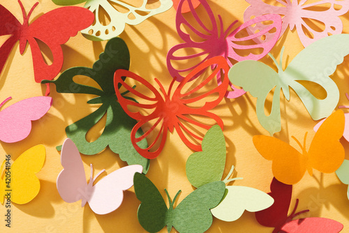 Paper cut out butterflies, on yellow background photo