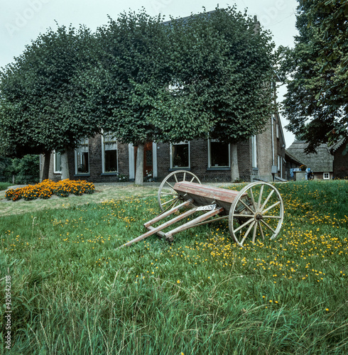 Fototapeta Naklejka Na Ścianę i Meble -  Historic farm Netherlands. Overijssel. Old machine for sale in garden. Kampereiland.