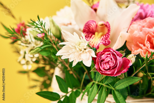 Bunch of fresh summer flowers on the yellow background