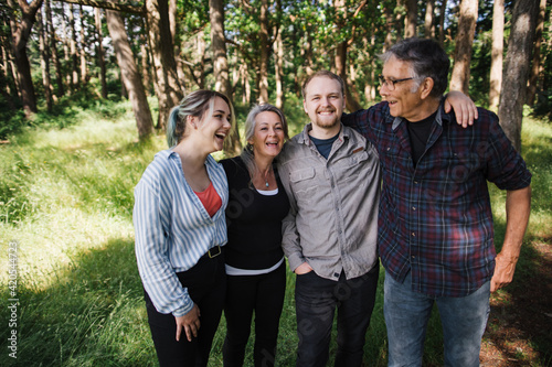 Happy family of four with older kids enjoying time outside in na photo