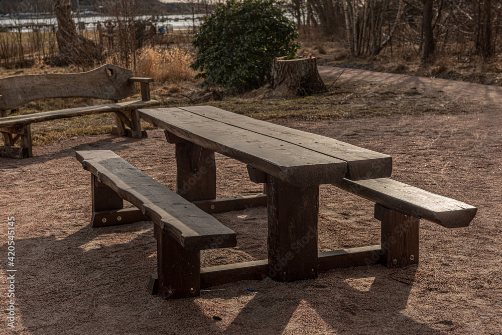 Wooden table and benches in a park. Wooden table and benches in a park.