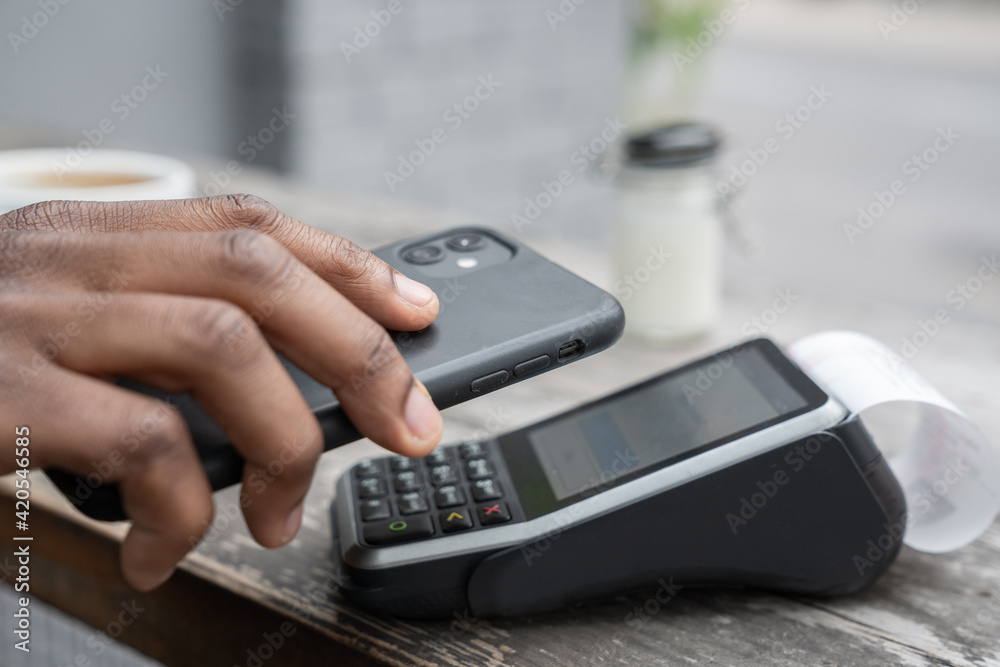 Crop View Of Man Using Cellphone For Paying Crop View Of Man Using Cellphone For Paying