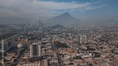 drone shot of a skyscraper against the Monterrey cityscape photo