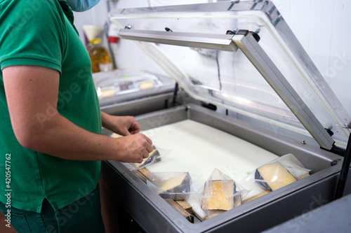 Cheese On A Machine Of Vacuum Packing.