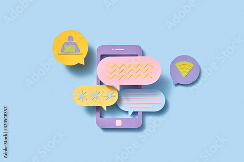 Papercraft phone with communication cloud icons.