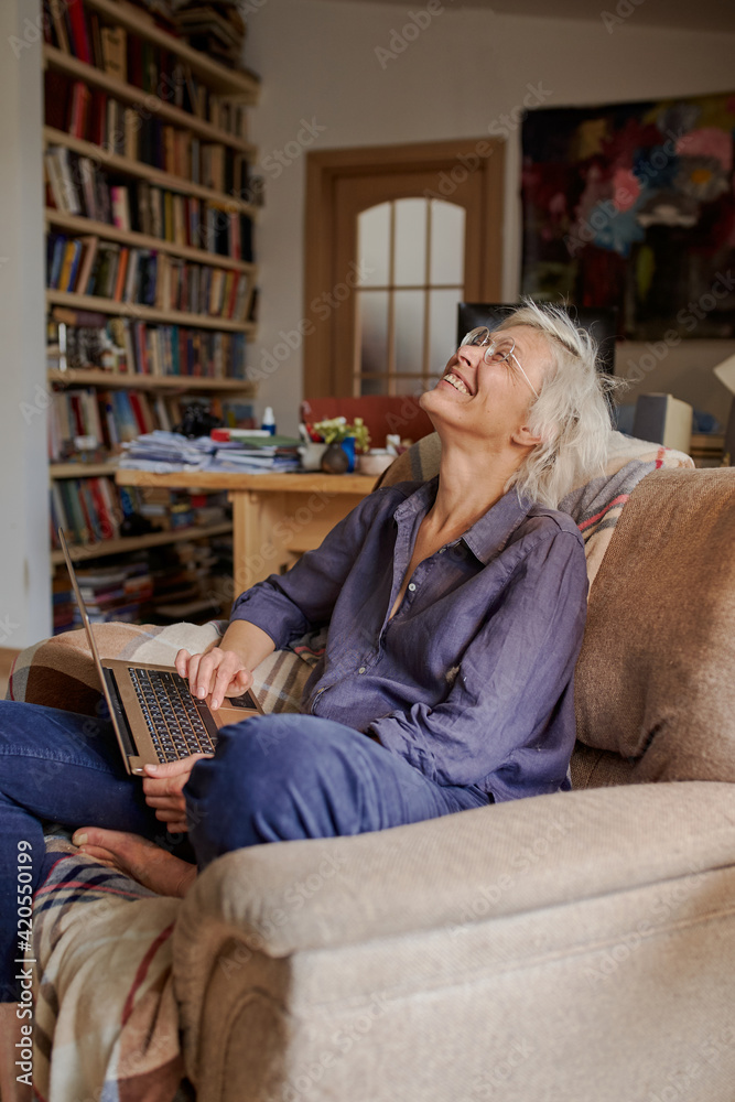 Active age ageless elderly woman working from home on a laptop Active age ageless elderly woman working from home on a laptop