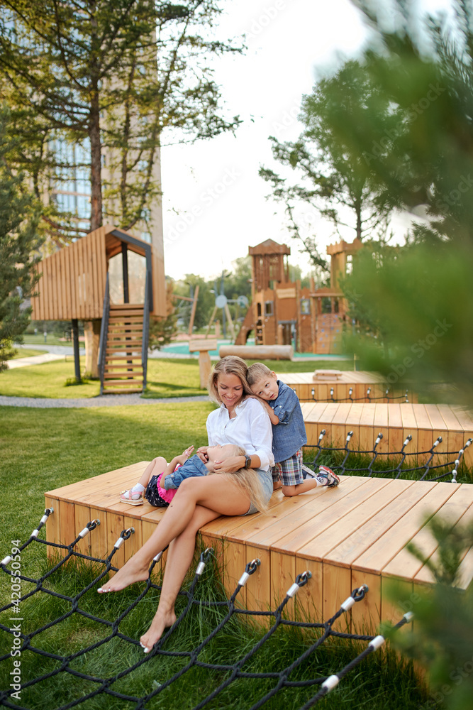 mother play with her children who play on the Playground near the house mother play with her children who play on the Playground near the house
