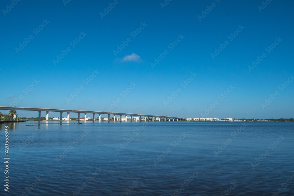 Roosevelt Bridge near downtown historic Stuart, Florida. Blue water, blue sky with a single cloud. Peaceful scene for this eastern Florida waterfront town.