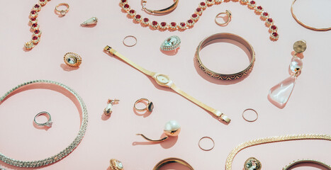 Jewellery,diamonds, ruby, gold, silver etc/ on pink background