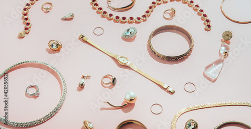 Jewellery,diamonds, ruby, gold, silver etc/ on pink background photo