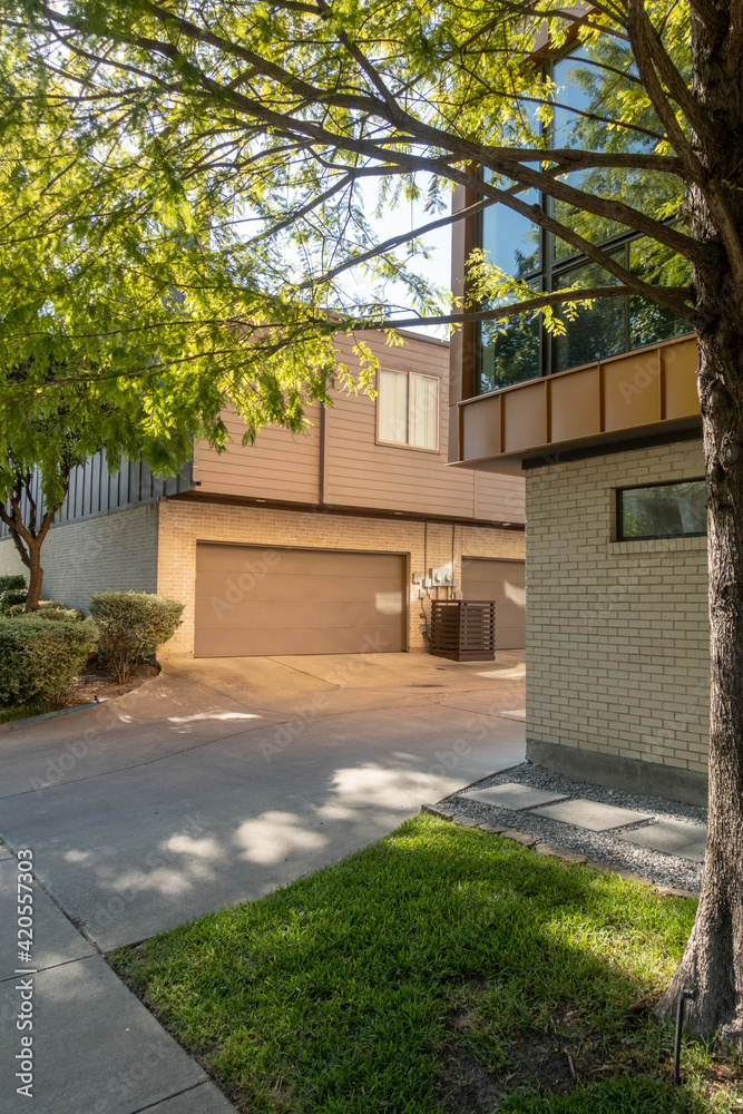 A view of a modern home from the sidewalk A view of a modern home from the sidewalk