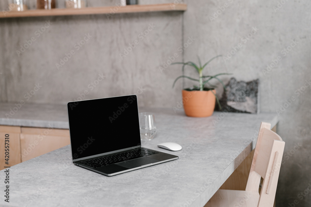 Laptop on table in modern minimalist workplace Laptop on table in modern minimalist workplace