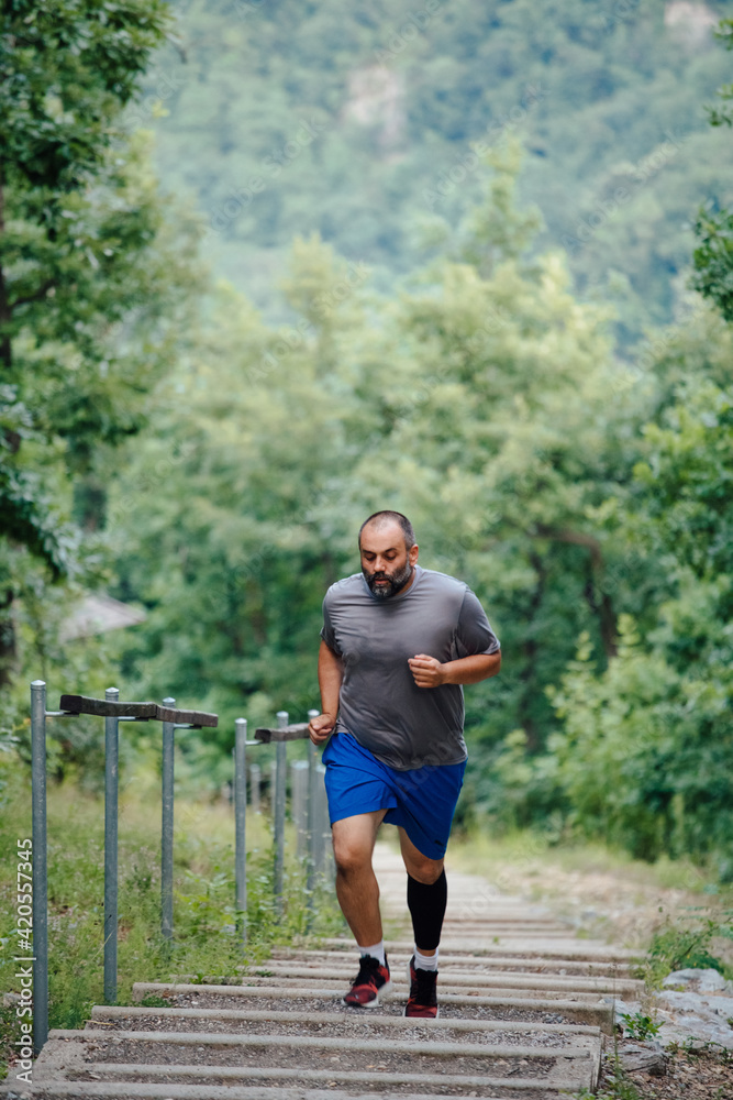 Stout Man Running On The Stairs Outdoors Stout Man Running On The Stairs Outdoors