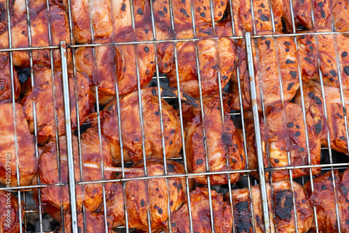 Grilled chicken on the grill. Tasty barbecue on the coils.