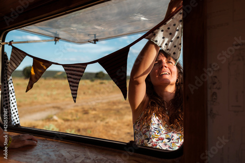 Woman decorating van with flags photo