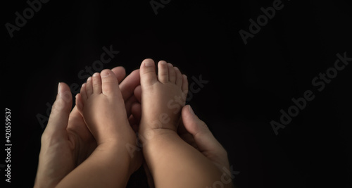 hand holding tinny baby feet