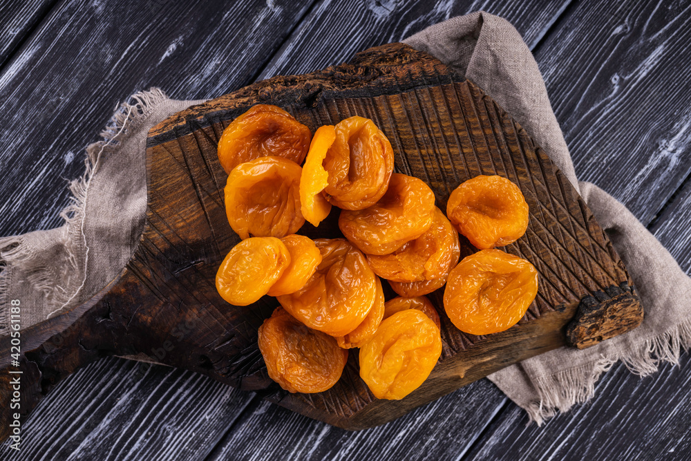 Fototapeta premium Dried raw apricots. Natural organic dried apricots, rustic still life.