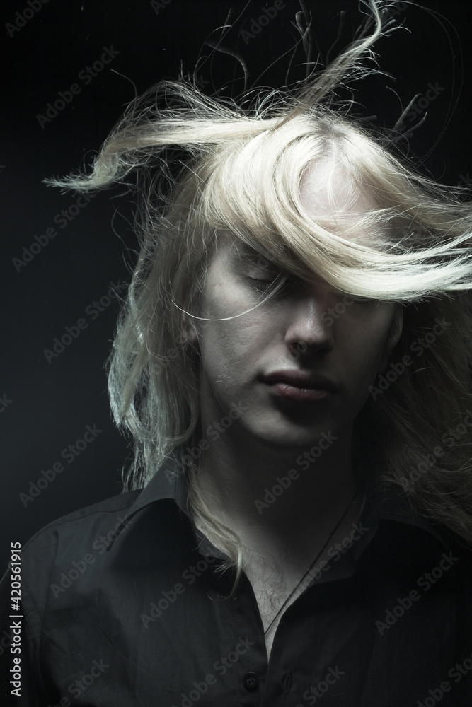 Young man with long blond hair Young man with long blond hair