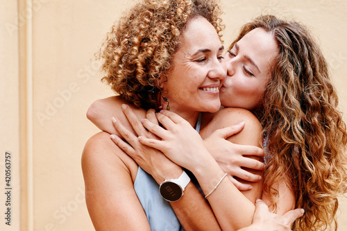 Woman kissing her mom on the cheek photo